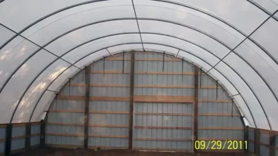 Hoop shed with wood framed end wall