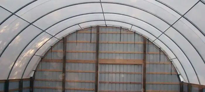 Hoop shed with wood framed end wall