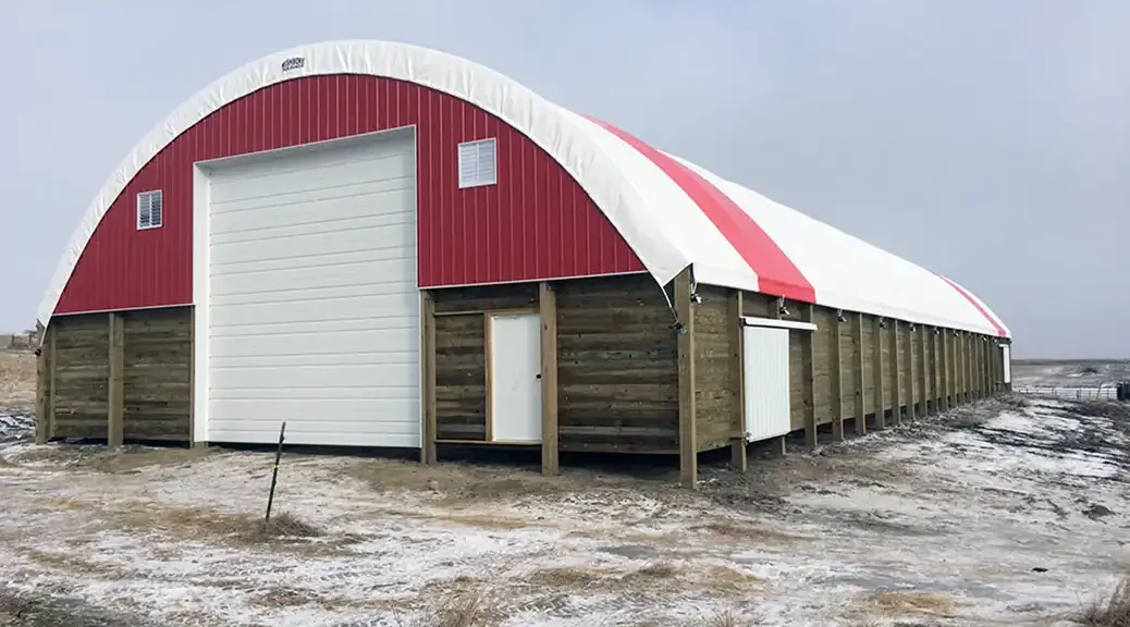 Hoop barn with side doors in a field